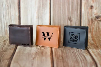 Assorted leather wallets with personalized names and logos.